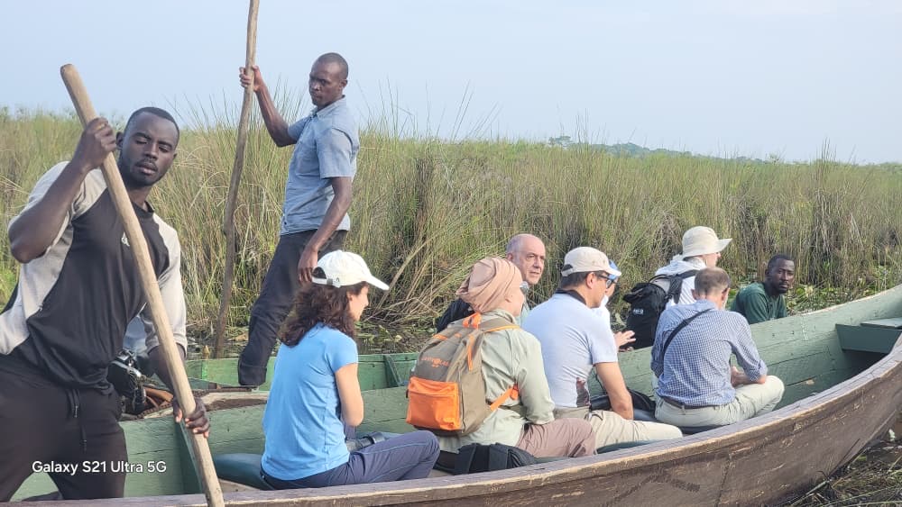 Local guides poling a canoe full of birdwatching guests through the swamp